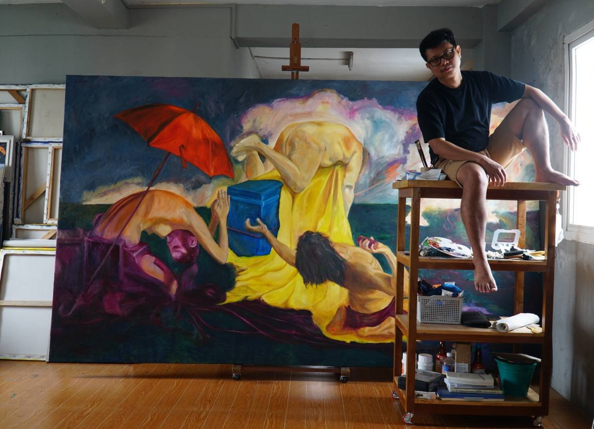 Saw Lin in his studio beside a large painting
